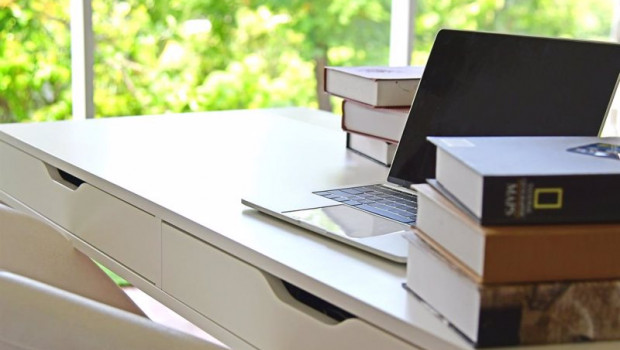 ep un escritorio con un ordenador portatil y varios libros