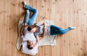 adult couple hugging sheet floor