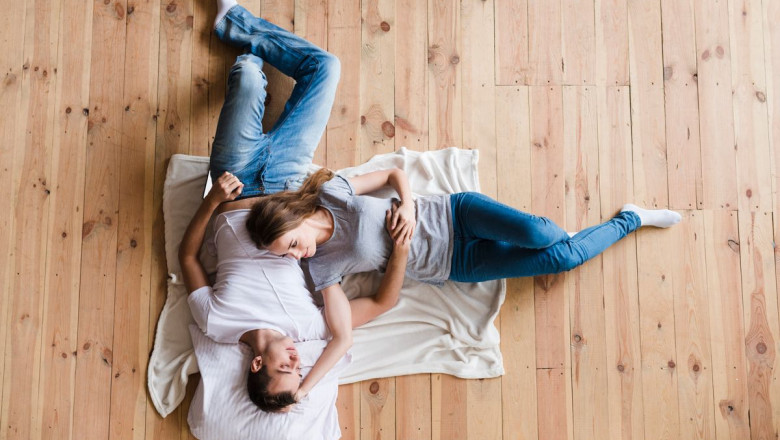 adult couple hugging sheet floor