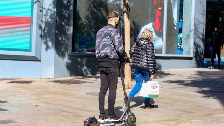 ep un joven pasea en patinete por la centrica calle de fuencarral en madrid