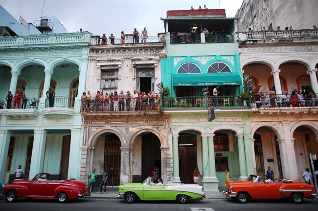 People stand on balconies prior to a fashion show displaying creations by German | ALEXANDRE MENEGHINI ep people stand on balconies prior tofashion show displaying creations by german