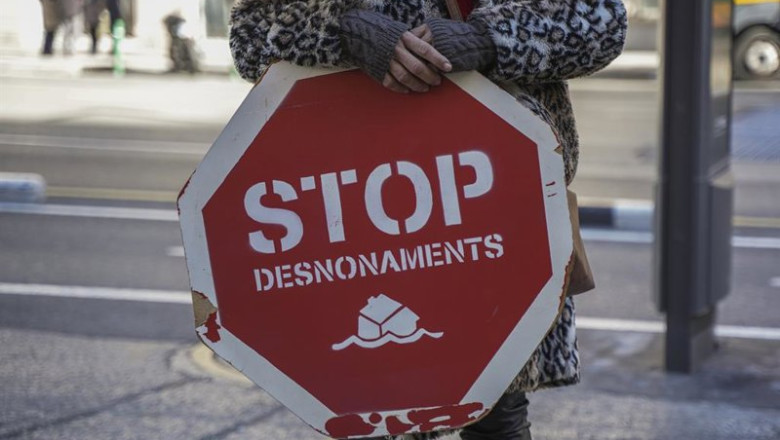 ep archivo   una persona sujeta un cartel contra los desahucios