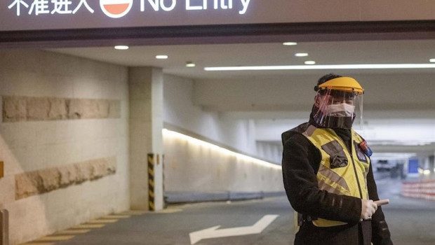 ep february 10 2020 shanghai china - a security guard in a surgical mask and a clear plastic visor