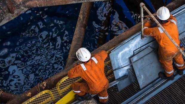 oil rig workers drilling offshore