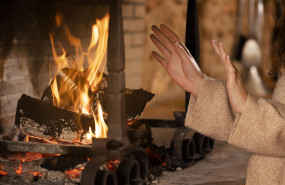 close up hands getting warm near fire 