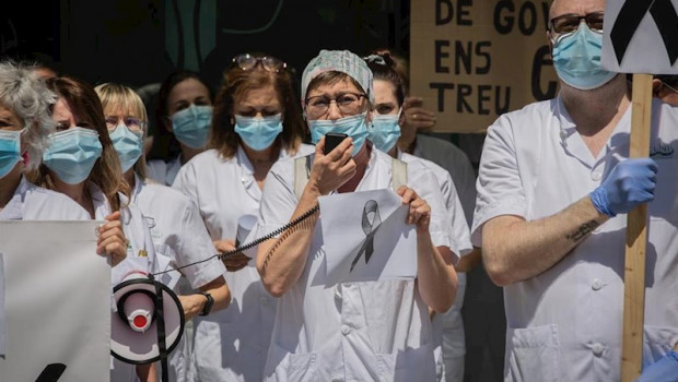 ep una sanitaria habla por un megafono junto a otros companeros de profesion a las puertas del