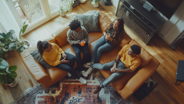 friends enjoying drinks together cozy couch modern living room filled with natural light greenery 
