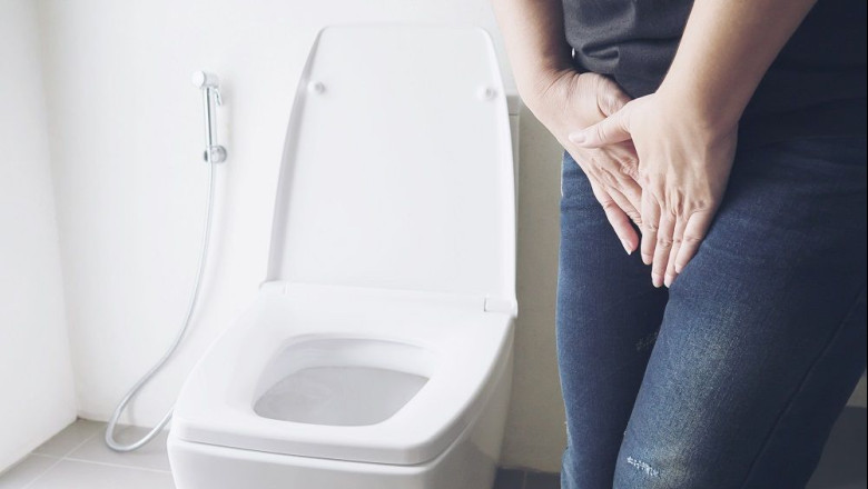 woman holding hand near toilet bowl health problem concept