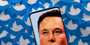 file photo illustration shows elon musk image on smartphone and printed twitter logos 