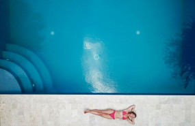 1582672656 woman lying on floor near pool 1460742
