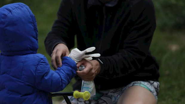ep un padre le pone a su hijo los guantes que un voluntario de payasos de circos reunidos les ha
