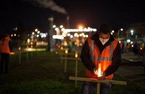 ep un trabajador de la fabrica coloca una vela durante un velatorio nocturno simbolico convocado por
