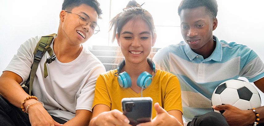 teens looking at phone together