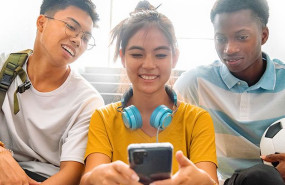 teens looking at phone together