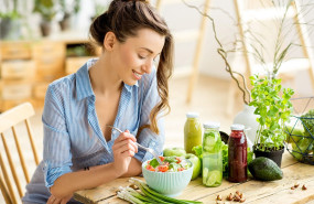 woman eating a healthy salad in her home woman eating a healthy salad in her home