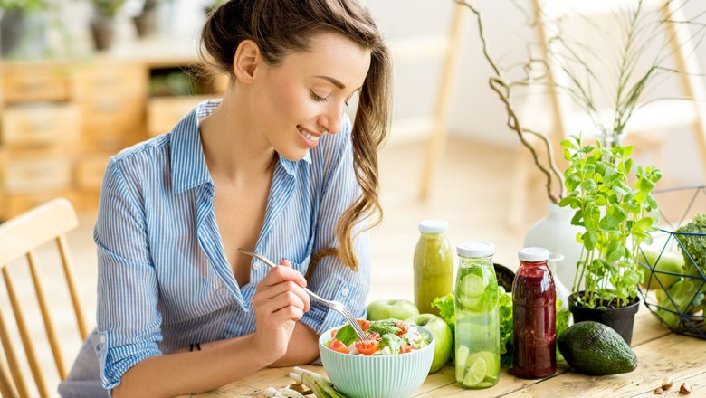 woman eating a healthy salad in her home