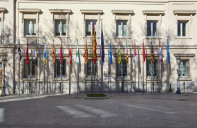 ep archivo   banderas de las comunidades autonomas frente a la fachada del palacio del senado en una