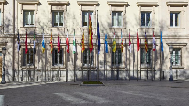 ep archivo   banderas de las comunidades autonomas frente a la fachada del palacio del senado en una